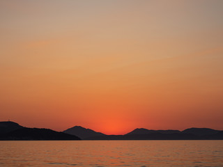 Sea with mountains at sunset