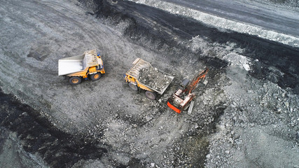 Coal mining in a quarry. A hydraulic excavator loads a dump truck. © nordroden