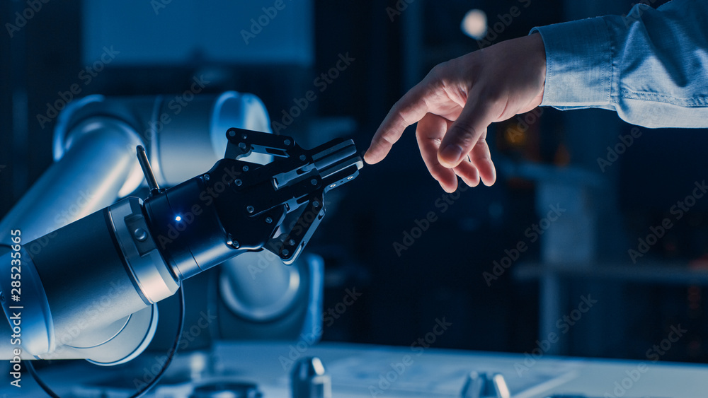 Poster futuristic robot arm touches human hand in humanity and artificial intelligence unifying gesture. co