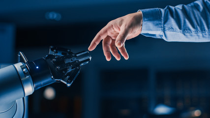 Futuristic Robot Arm Touches Human Hand in Humanity and Artificial Intelligence Unifying Gesture. Conscious Technology Meets Humanity. Concept Inspired by Michelangelo's Creation of Adam - obrazy, fototapety, plakaty