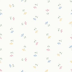 Seamless pattern of small pastel pink, blue and yellow flowers.