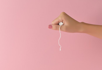 Woman hiding a tampon in the fist