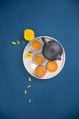 Minimal simplicity layout moon cakes on blue background for Mid-Autumn Festival, creative food design concept, top view, flat lay, copy space.