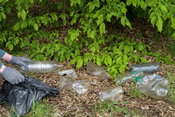 Young boy volunteers gathering garbage in park