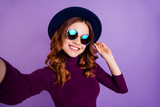 Close up photo of charming lady make photo video call touch accessory isolated over purple violet background