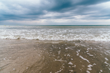 Beach with dark clouds and incoming rain storm