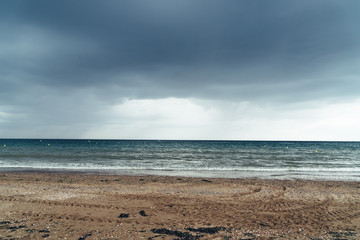 Beach with dark clouds and incoming rain storm