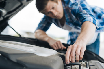 Close-up of man repairing engine