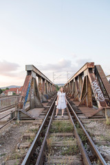 Fototapeta na wymiar Woman on the railway bridge