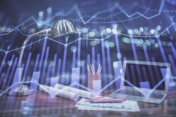 Stock market graph on background with desk and personal computer. Multi exposure. Concept of financial analysis.