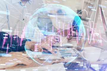 Multi exposure of chart with man typing on computer in office on background. Concept of hard work.