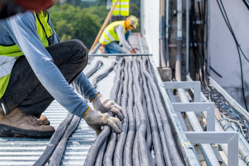 Workers are moving cables in construction sites.