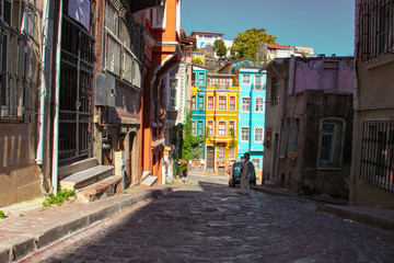 Fototapeta na wymiar woman and colorful old buildings in Balat in Istanbul