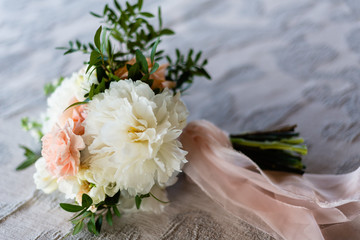 bouquet of flowers of the bride composed of peonies and roses
