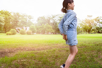 Asian child girl has diarrhoea, hold her butt,hands touch her bottom having abdominal...