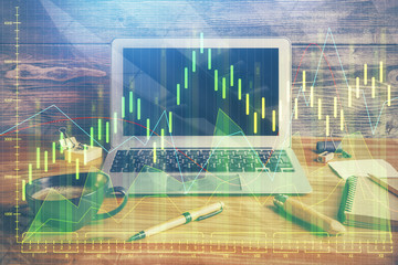 Multi exposure of chart and financial info and work space with computer background. Concept of...