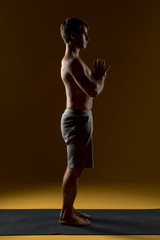 Man meditating on yoga mat