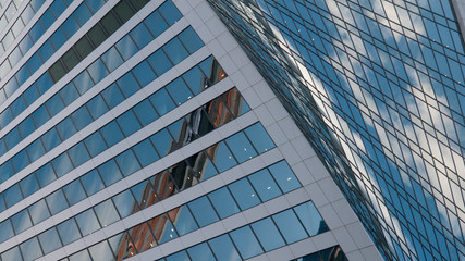 modern office building with reflection in windows of building