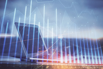 Forex market chart hologram and personal computer background. Double exposure. Concept of investment.