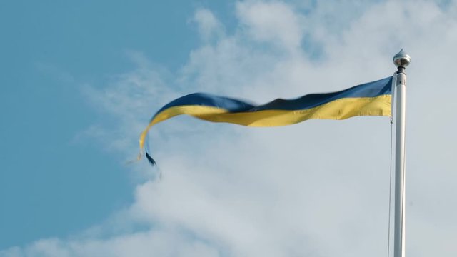 Swedish pennant flying against a blue sky. Pennant ripped by the wind  at the end.