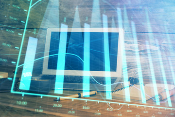 Financial graph colorful drawing and table with computer on background. Double exposure. Concept of...