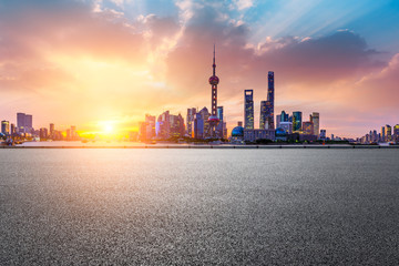 Shanghai skyline and modern buildings with empty asphalt road at sunrise,China