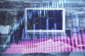 Double exposure of forex chart and work space with computer. Concept of international online trading.