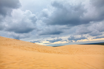Fototapeta na wymiar landscape with low clouds over the sandy duna