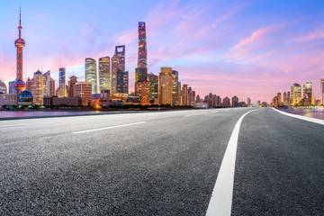 Fototapeta na wymiar Shanghai skyline and modern buildings with empty asphalt highway at sunrise,China