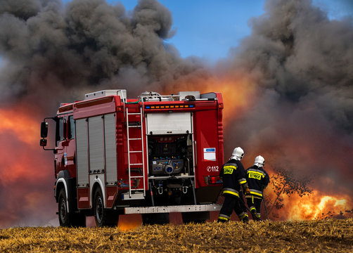 Fire Truck And Firefighters During The Fire Extinguishing Action