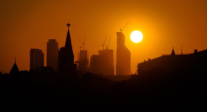 silhouette of city at sunset