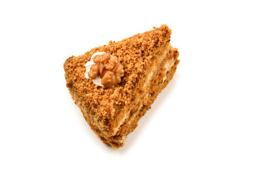 Peace of honey cake isolated on white background.