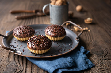 Sweet Linzer cookie cups with walnut filling, topped with chocolate