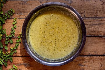 Bowl with ingredients making a cake on a wooden surface