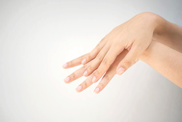 Young woman using a hand rub creams