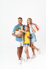 Fototapeta premium Photo of attractive family woman and man with daughter holding food products and shopping bags