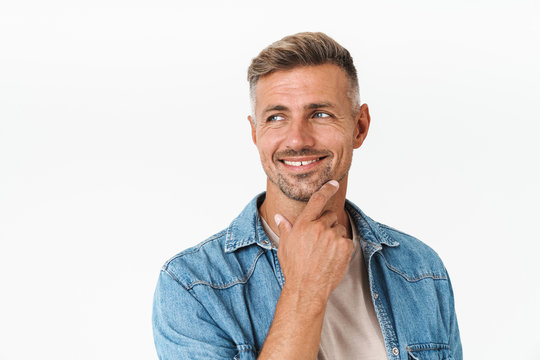 Photo of unshaved guy in denim shirt smiling and looking aside at copyspace