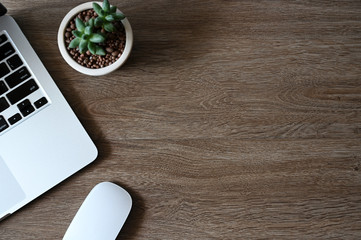 Working with Laptop computer and cactus copy space on table background.Top view style.Minmal workspace,business Concept