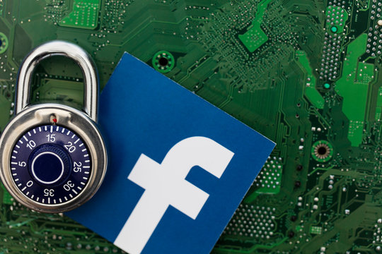 LONDON, UK - AUGUST 8th 2018: Facebook data security concept. A combination padlock with the facebook social media logo