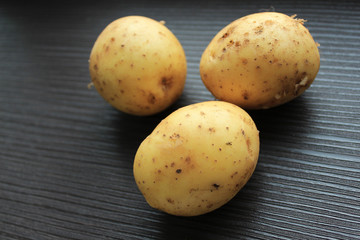  Young potato lies on the table