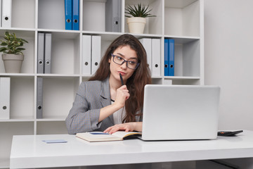 Thoughtful young woman working in office