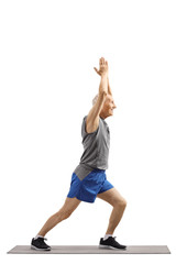 Senior man practicing yoga pose on an exercise mat