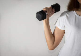 Female workout with metal dumbbell.