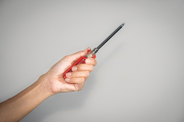 Female holding screwdriver in hand.