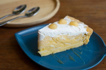 A dish of sliced  cake with cream on-top .