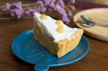 A dish of sliced  cake with cream on-top .
