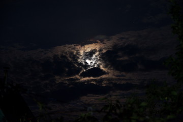 Obraz premium moon in the black sky peeps out of the clouds