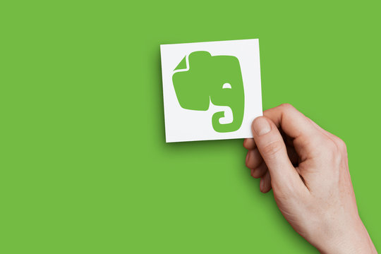 LONDON, UK - October 30th 2018: Hand holding Evernote logo. Evernote is an app for note taking and organizing