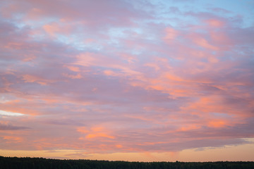 Fototapeta premium Calm evening with burning sky and forest in the background. Colourful sunset sky. Peaceful time camping in nature. Space for text