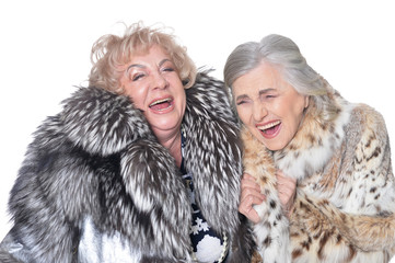 Portrait of senior women in fur coats isolated on white background